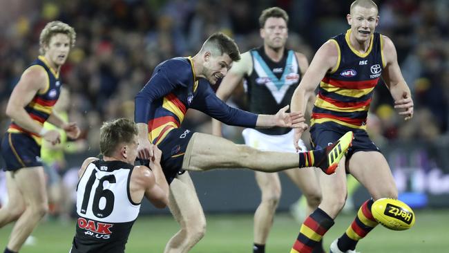 Port’s Ollie Wines tries to stop Adelaide’s Bryce Gibbs on Saturday. Picture: SARAH REED