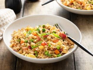 Breakfast fried rice with bacon, carrots, peas, green onions and scrambled eggs