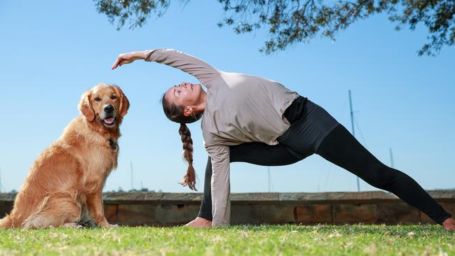 Yoga teacher and dog sitter Ann Repp Olsen with Sammy, at Baere Park, Elisabeth Bay, today. Picture: Justin Lloyd