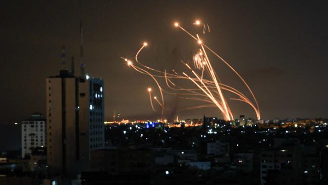 An Israeli missile launched from the Iron Dome defence missile system attempts to intercept a rocket, fired from the Gaza Strip, over the city of Netivot in southern Israel on October 8, 2023. Picture: AFP