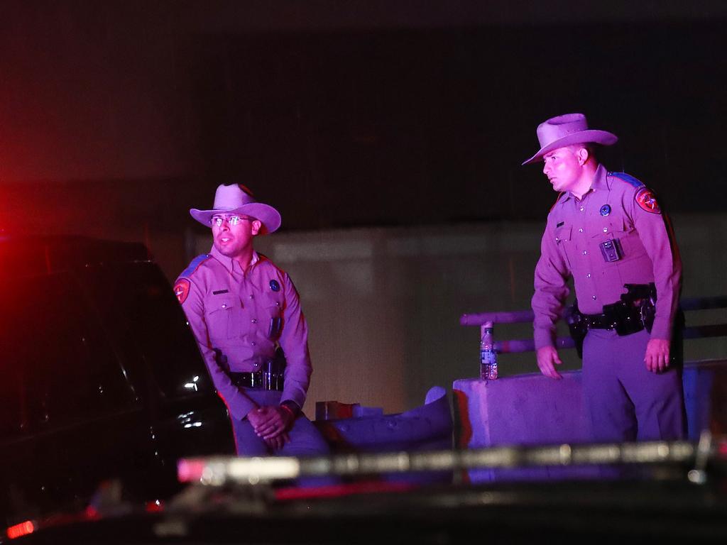 Police keep watch outside Walmart near the scene of a mass shooting which left at least 22 people dead.