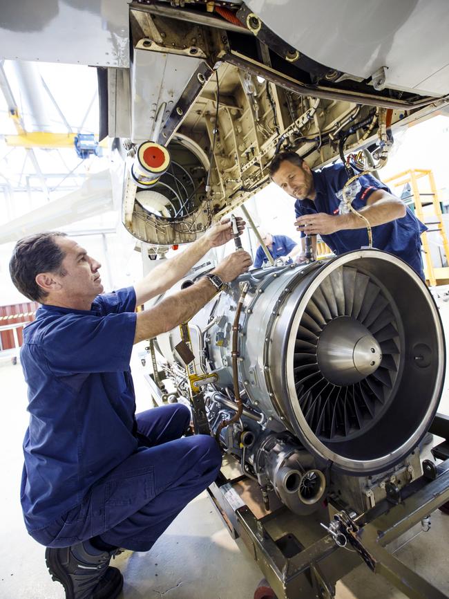 Engineers Carel Neuiwoudt and Neil Davis work on a Hawk at BAE Systems' Williamtown base.