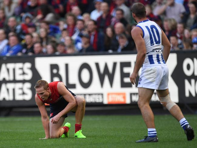 Ben Cunnington stands over Bernie Vince after giving him one in the stomach. Picture: AAP