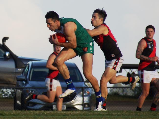 Michael Firrito takes a strong mark ahead of Emerald’s Nic Jansen. Picture: Robyn Kuys