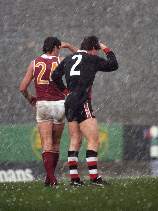 Hail pelts St Kilda and Brisbane players Roger Merrett and Danny Frawley in 1993.