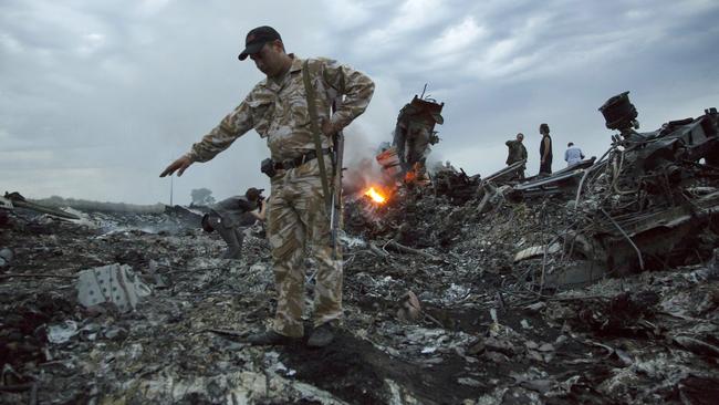 People walking amongst the debris at the crash site of MH17. Picture: Dmitry Lovetsky