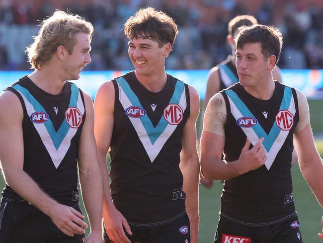 ADELAIDE, AUSTRALIA - JULY 06: Jason Horne-Francis, Connor Rozee and Zak Butters of the Power celebrate their win during the 2024 AFL Round 17 match between the Port Adelaide Power and the Western Bulldogs at Adelaide Oval on July 05, 2024 in Adelaide, Australia. (Photo by James Elsby/AFL Photos via Getty Images)