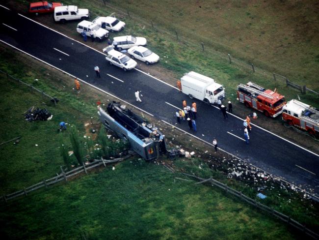 The bus on its side after colliding with the semi-trailer truck. Picture: News Ltd