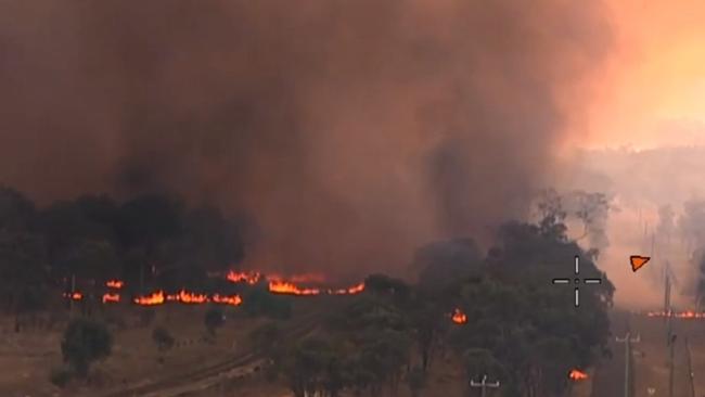 The fire burns close to homes at Wallangarra. Picture: QFES