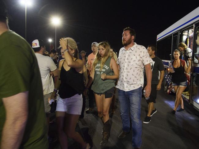 People arrive at Thomas &amp; Mack Centre via bus after hiding inside the Sands Corporation plane hangar. Picture: AP