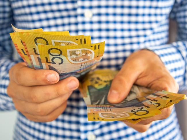 Man handling fifty dollar notes finance. Money and bills economy  Picture: istock