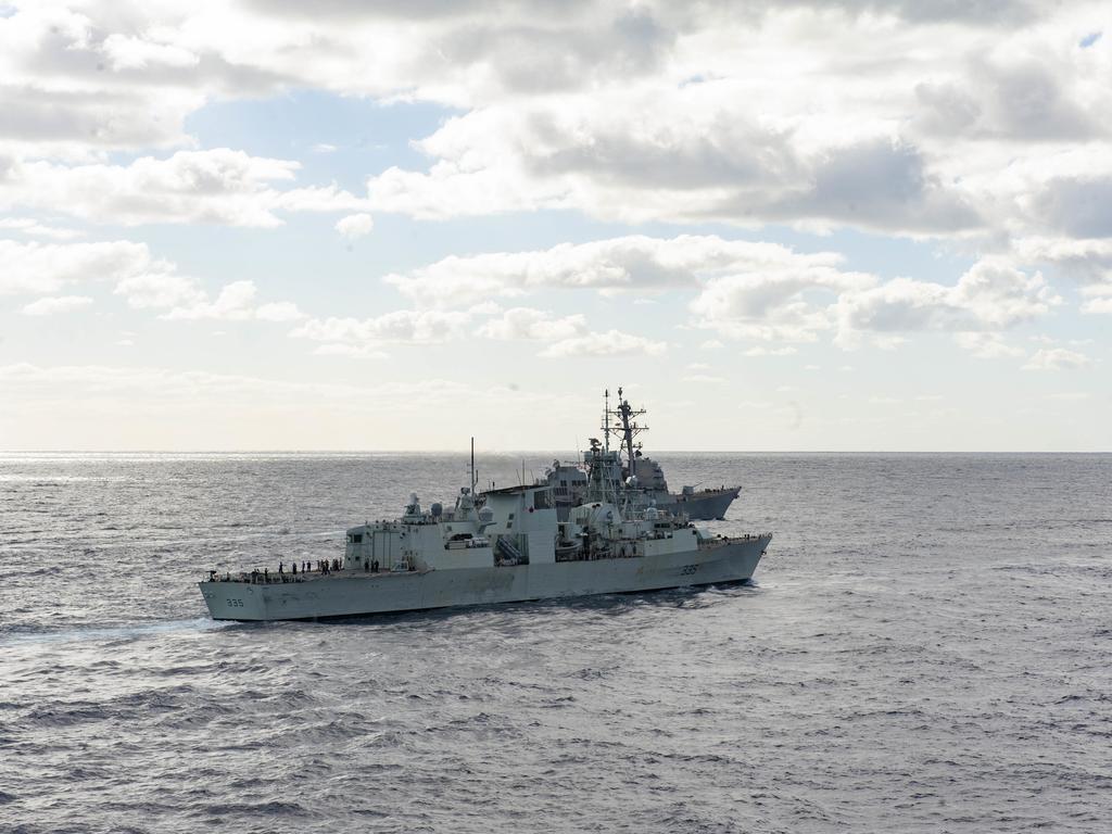 210722-N-XB010-1004 CORAL SEA (July 22, 2021) HMCS Calgary (FFH 335), foreground, and USS Rafael Peralta (DDG 115) steam in formation alongside partner nations and allies during Talisman Sabre (TS) 21. This is the ninth iteration of Talisman Sabre, a large-scale, bilateral military exercise between Australia and the U.S. involving more than 17,000 participants from seven nations. The month-long multi-domain exercise consists of a series of training events that reinforce the strong U.S./Australian alliance and demonstrate the U.S. MilitaryÃ¢â&#130;¬â&#132;¢s unwavering commitment to a free and open Indo-Pacific. (U.S. Navy photo by Mass Communication Specialist 2nd Class Desmond Parks)