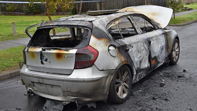 The torched getaway car used by the hitmen, which was stolen.