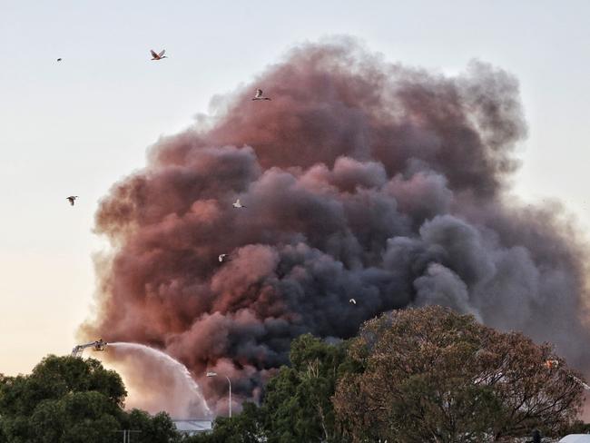 The smoke billows across the city. Picture: Hamish Blair