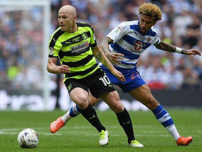 Aaron Mooy of Huddersfield Town attempts to get away from Daniel Williams of Reading during the Sky Bet Championship play off final.