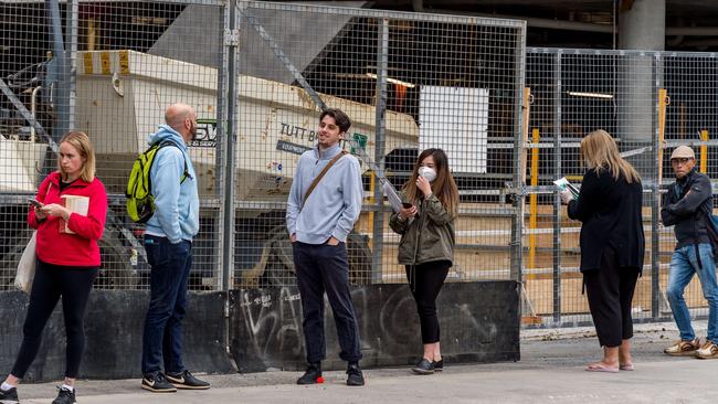 Abbotsford Centrelink queuers keep a safe distance from each other in line. Picture: Jake Nowakowski