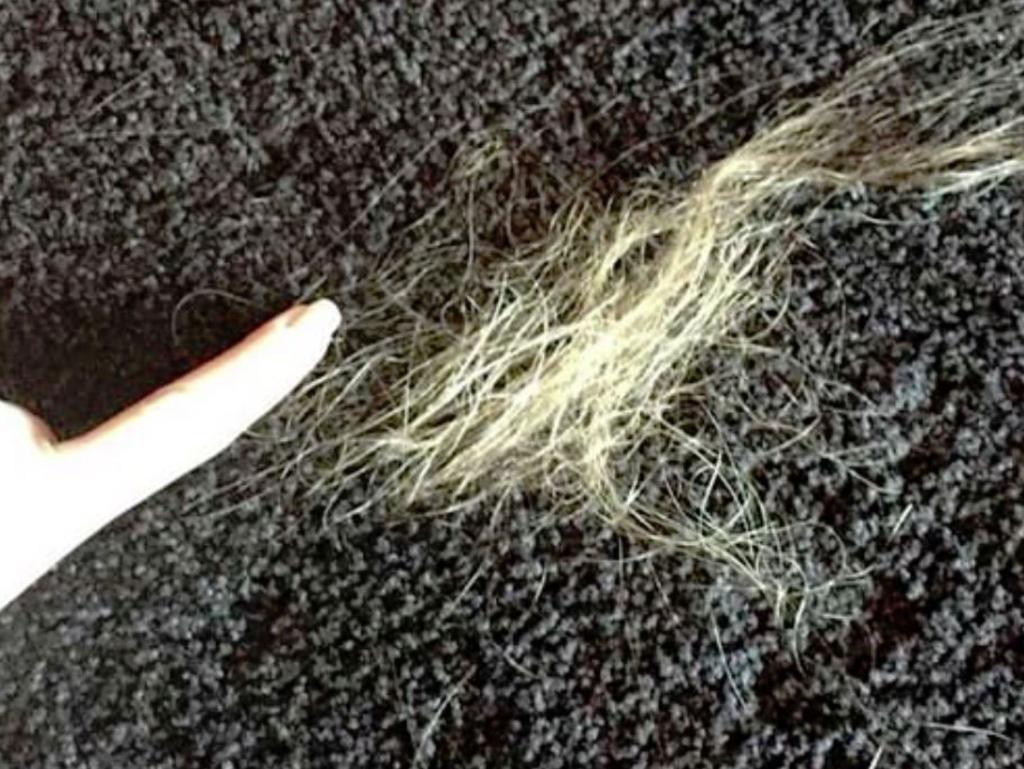 Amber Heard points to clumps of hair left on the ground after Johnny Depp allegedly tore it from her head. Picture: Fairfax County Court