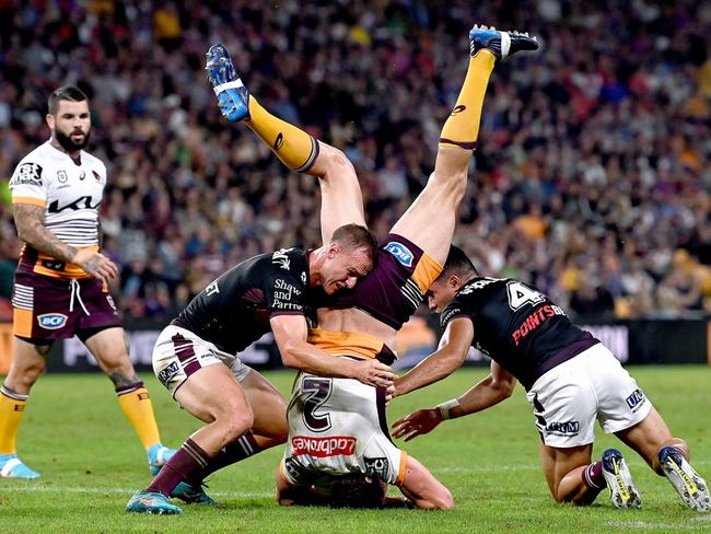 Corey Oates of the Broncos is placed in a vulnerable position as he is up-ended in the tackle during the NRL match between the Manly Sea Eagles and the Brisbane Broncos. Pictures: Bradley Kanaris