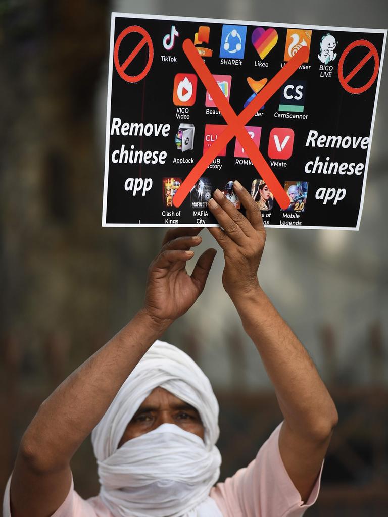 A member of the Working Journalist of India (WJI) holds a placard urging citizens to remove Chinese apps. Picture: Prakash Singh / AFP