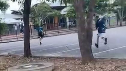 A 14-year-old Palmerston College student flees as a glass bottle is launched in his direction near Palmerston Bus Terminal, March 24, 2024. Picture: Supplied