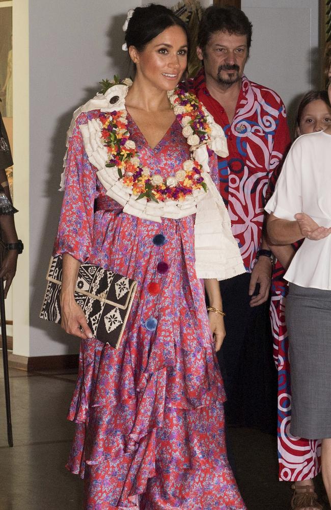 Meghan with the clutch bag she bought at the markets attends a morning tea reception at the British High Commissioner’s residence in Suva, Fiji. Picture: Samir Hussein.