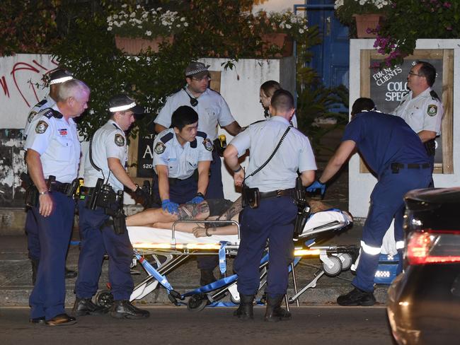 Paramedics take Amati away from the scene and off to hospital. Picture: Gordon McComiskie