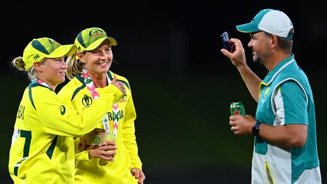 Matthew Mott, Meg Lanning and Alyssa Healy celebrate an Australian World Cup win.