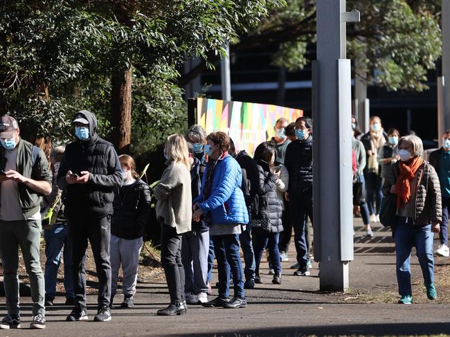 People wait to be vaccinated at the NSW Health Vaccination Hub in Sydney Olympic Park. Picture: Tim Hunter.