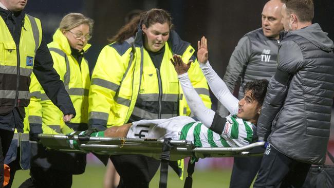 Daniel Arzani is stretchered from the field after injuring his knee.