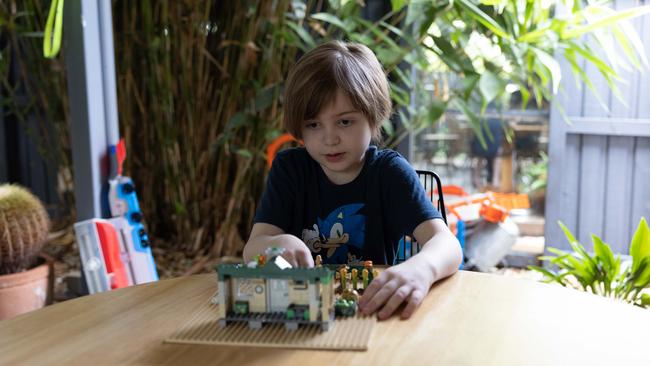 Odinn Meehan enjoying some play before it’s time to put on his uniform, turn on his laptop at home, and go to school. Picture: David Kelly