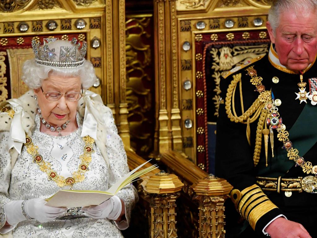 Britain's Queen Elizabeth II reads the government’s speech while Prince Charles watches on. Picture: TOBY MELVILLE / POOL / AFP.