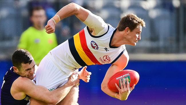 Matt Crouch is tackled by Hayden Ballantyne.