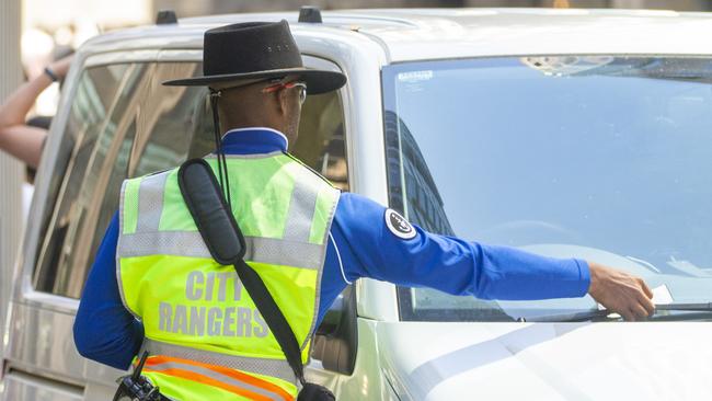 SYDNEY, AUSTRALIA - NewsWire Photos NOVEMBER 15, 2020:  A city ranger is seen putting a parking fine on a car in SydneyÃs CBD. Picture: NCA NewsWire / Jenny Evans