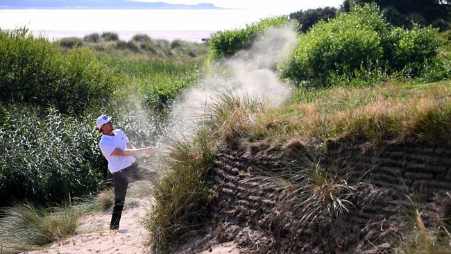 Travis Smyth of Australia plays his 4th shot on the 17th hole, a ‘huge surprise’ after it landed in the infamous hole dubbed Little Eye. Picture: Getty Images