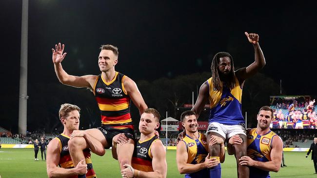 Brodie Smith oand Nic Naitanui are chaired off 200th games. Picture: Sarah Reed/AFL Photos via Getty Images