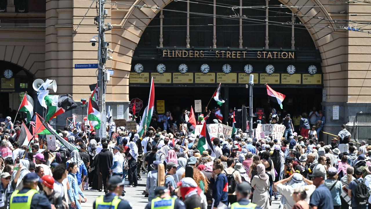 Many protesters were holding Palestinian flags and anti-Israel signs. Picture: Tony Gough