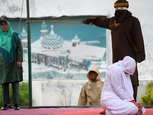 A Muslim woman gets caned 23 times after being caught in proximity with her boyfriend in Banda Aceh in October last year. Picture: Chaideer Mahyuddin/AFP