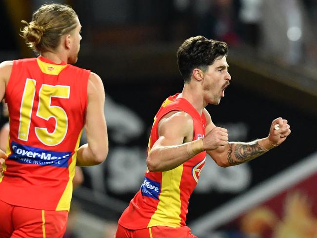 Alex Sexton (right) of the Suns celebrates kicking a goal during the Round 22 AFL match between the Gold Coast Suns and the Brisbane Lions at Metricon Stadium on the Gold Coast, Saturday, August 18, 2018. Picture: AAP Image, Darren England.