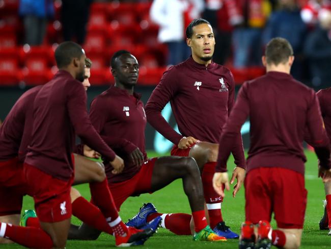 LIVERPOOL, ENGLAND - DECEMBER 11:  Virgil van Dijk of Liverpool (C) warms up with team mates prior to the UEFA Champions League Group C match between Liverpool and SSC Napoli at Anfield on December 11, 2018 in Liverpool, United Kingdom.  (Photo by Clive Brunskill/Getty Images)
