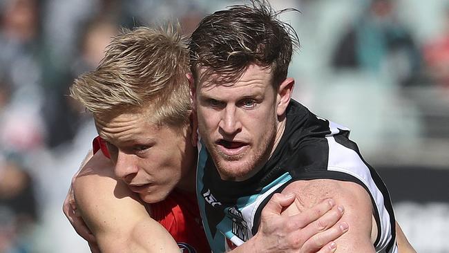 Port Adelaide’s Tom Jonas keeps his eyes on the ball as Swan Isaac Heeney challenges. Picture: SARAH REED