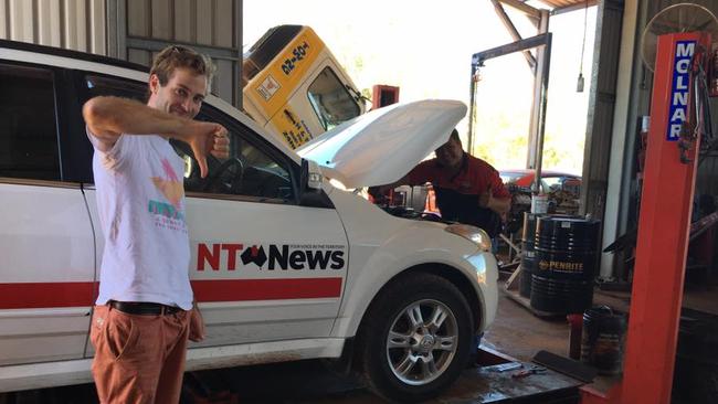 He is also good with his hands in a very blokey way. Not only can he type, he also risks getting his hands dirty by giving the thumbs down sign that the work car is broken, when he is standing near greasy areas. Picture: Facebook.