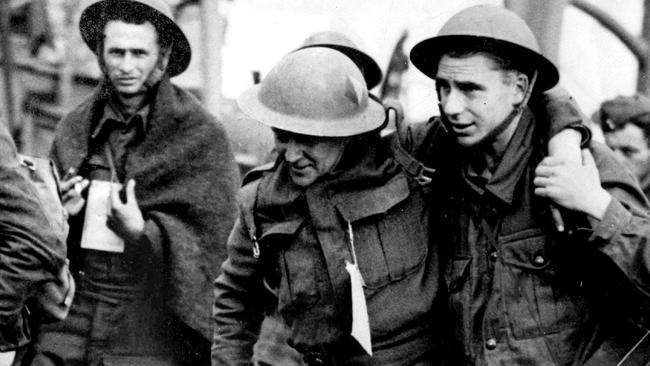 Evacuation of Dunkirk France May 1940. BEF men were rescued on a variety of vessels - helping a wounded man ashore at Dover. WWII British Armed Forces history