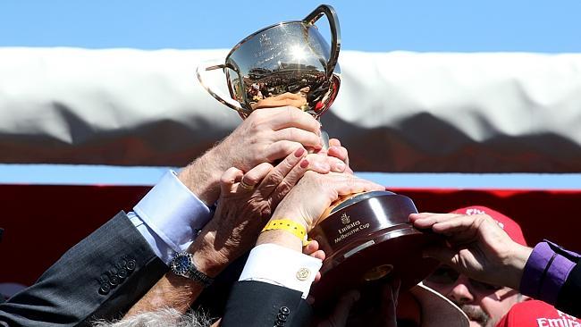 Fiorente's owners hold up the Melbourne Cup.