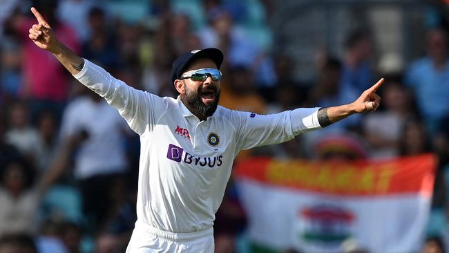 India's captain Virat Kohli reacts after England's James Anderson lost his wicket. (Photo by Glyn KIRK / AFP)