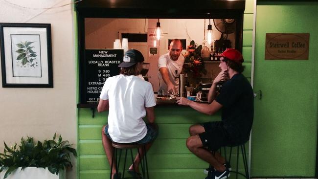 The iconic green facade of Surfers Paradise hole-in-the-wall coffee shop, aptly named Stairwell Coffee