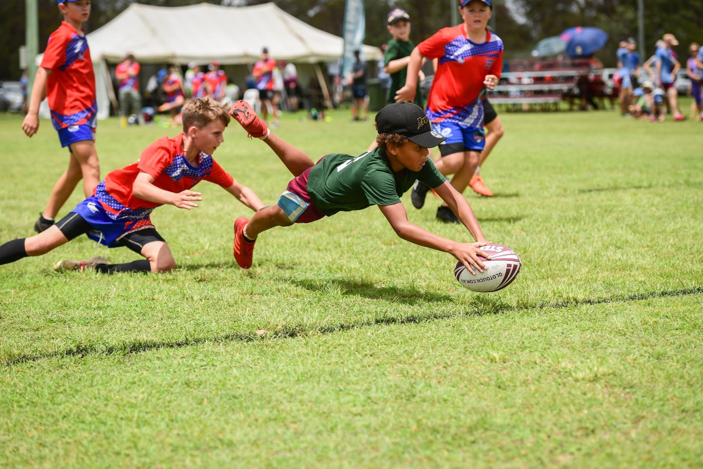 A future champion to the game, LeBron Tanner dives to he line to score for the Bundaberg under 12s.