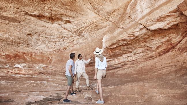 Mutawintji National Park tour guide Keanu Bates showing visitors Aboriginal rock art.