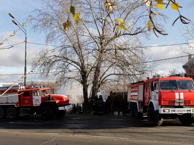 Rescuers work to extinguish a fire in a building following a drone attack in the village of Stanovoye, on November 10. Picture: Tatyana Makeyeva/AFP