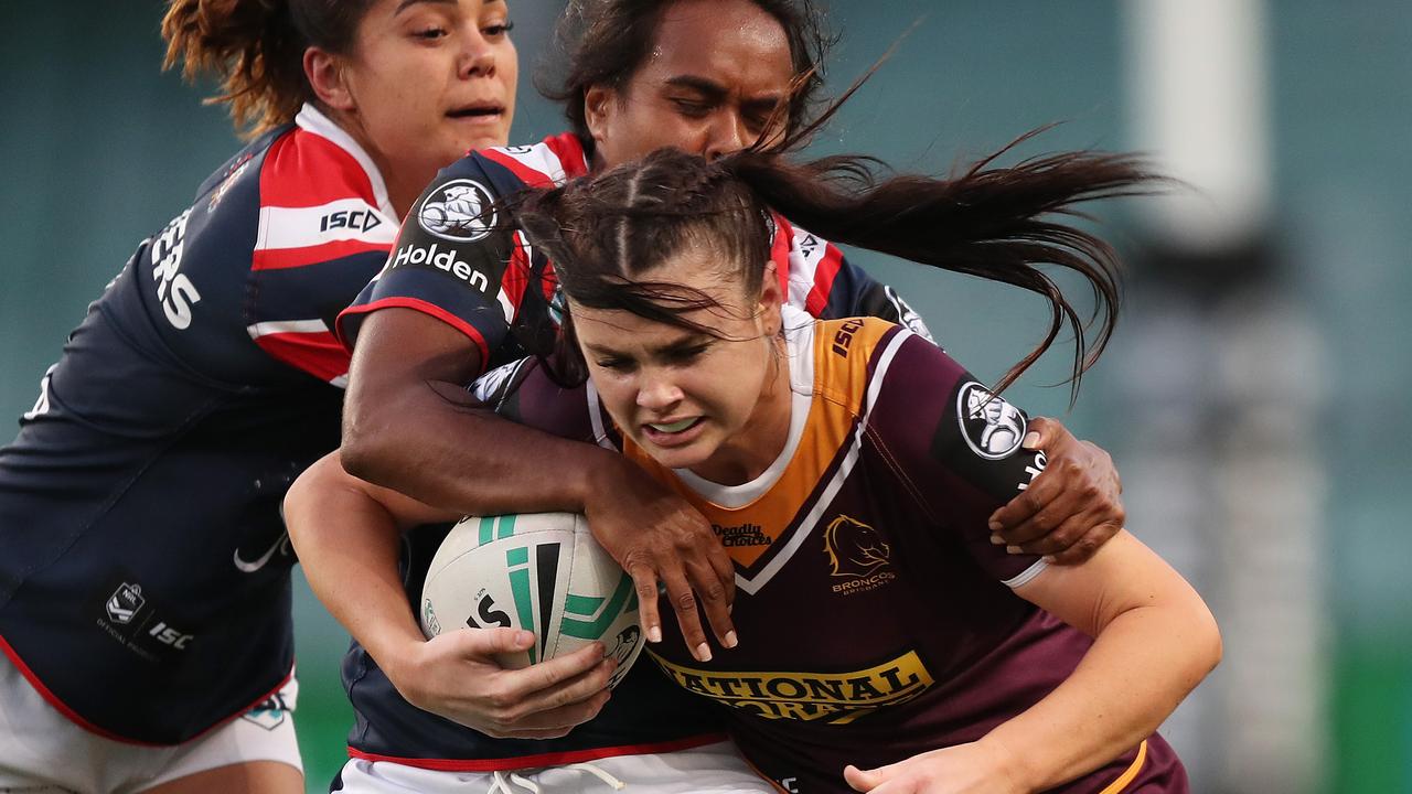 Broncos player Amber Pilley is tackled.