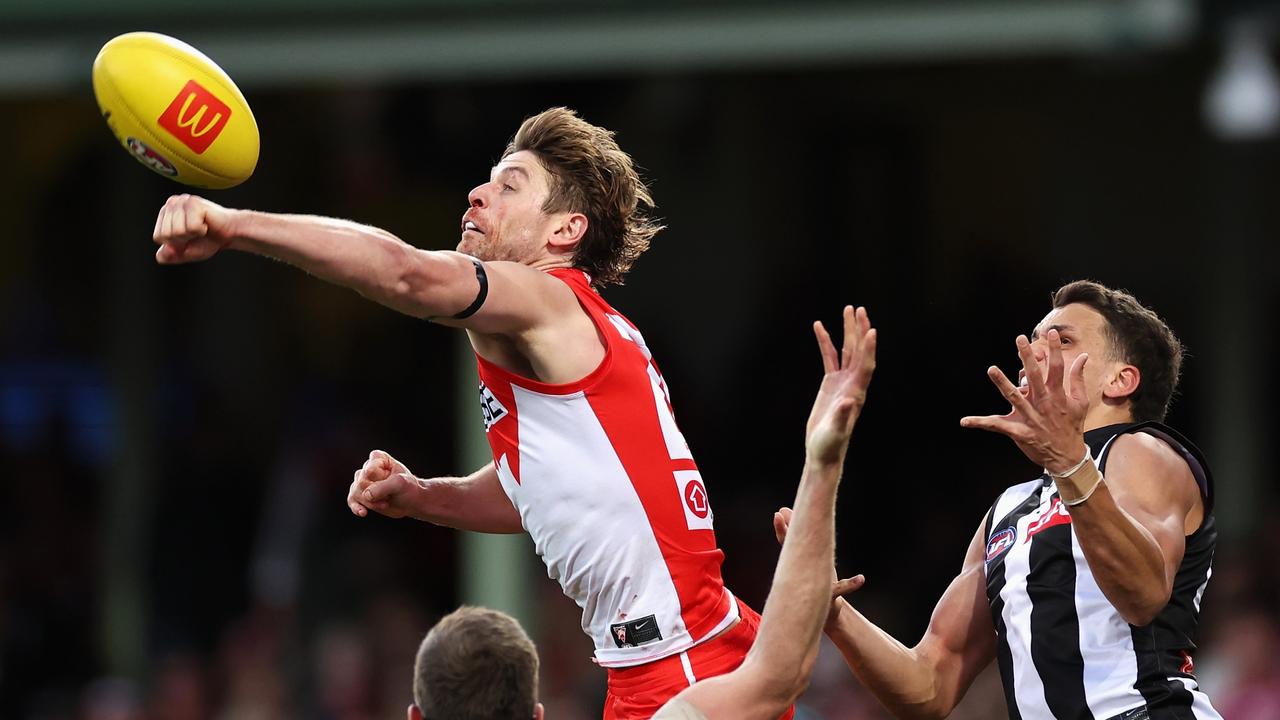 Dane Rampe gets a fist on the ball ahead of Magpie Ash Johnson. Picture: Cameron Spencer/Getty Images